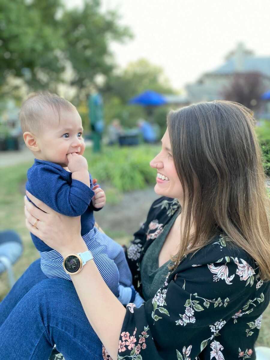 Michelle holds Sami on her knees while enjoying the outdoors together.