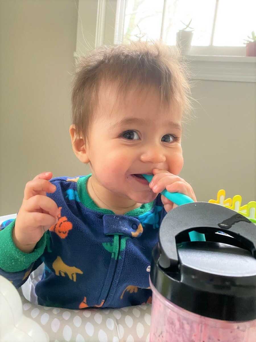 Sami sneaks a sip from his mommy's water bottle.