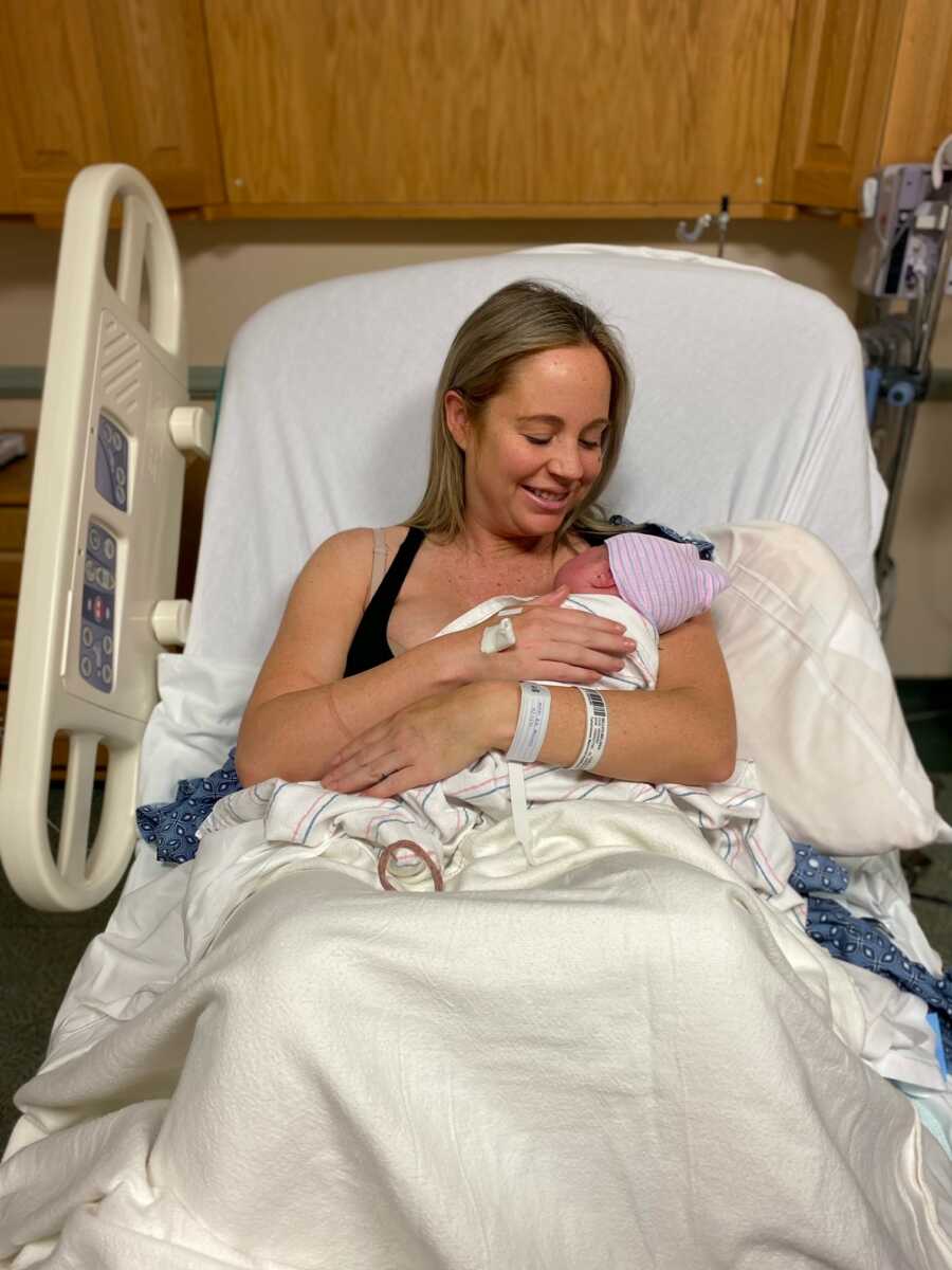 mom holding her new born daughter after she gave birth