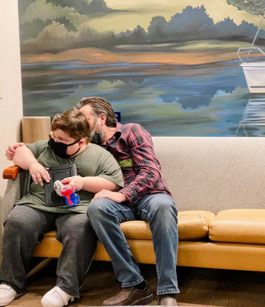 dad with son at the hospital waiting for test so the family can get answers for son