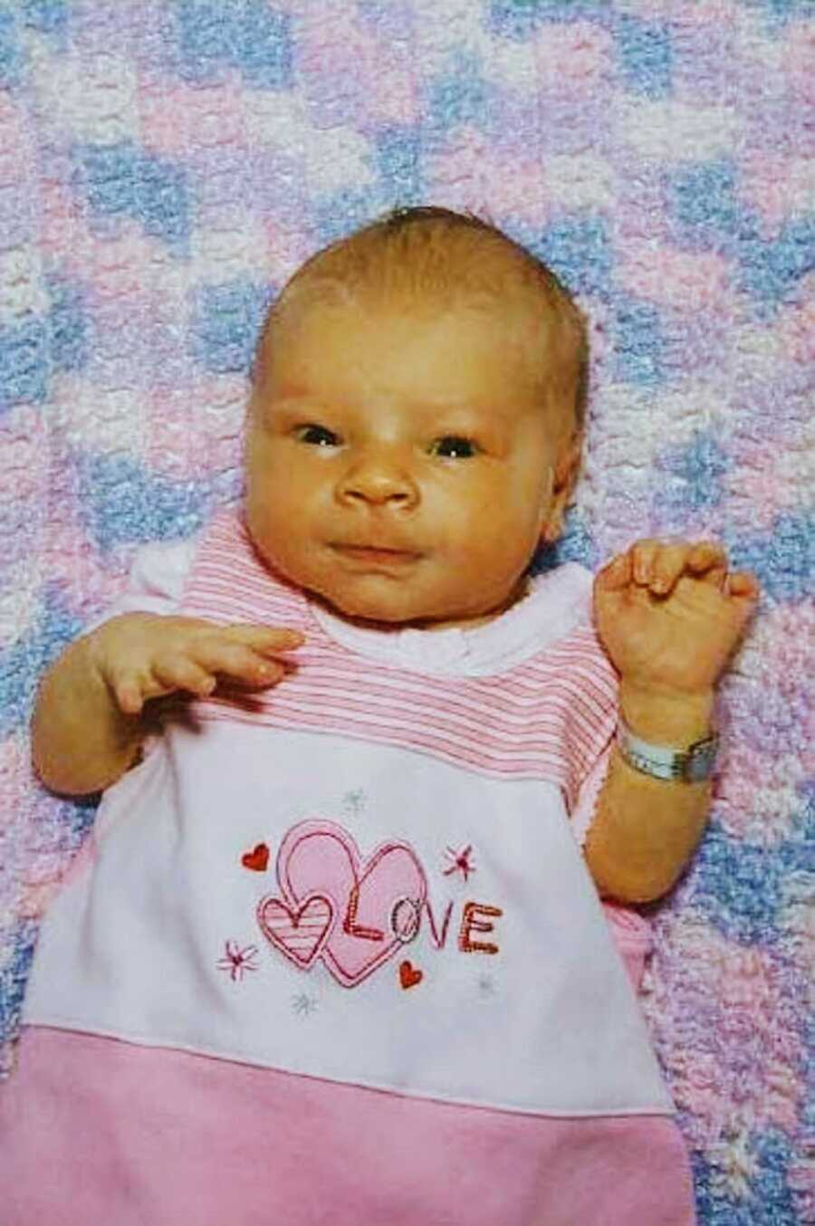 Newborn baby girl wearing pink dress