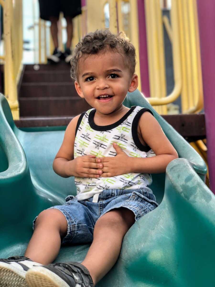 toddler boy smiling at the playground