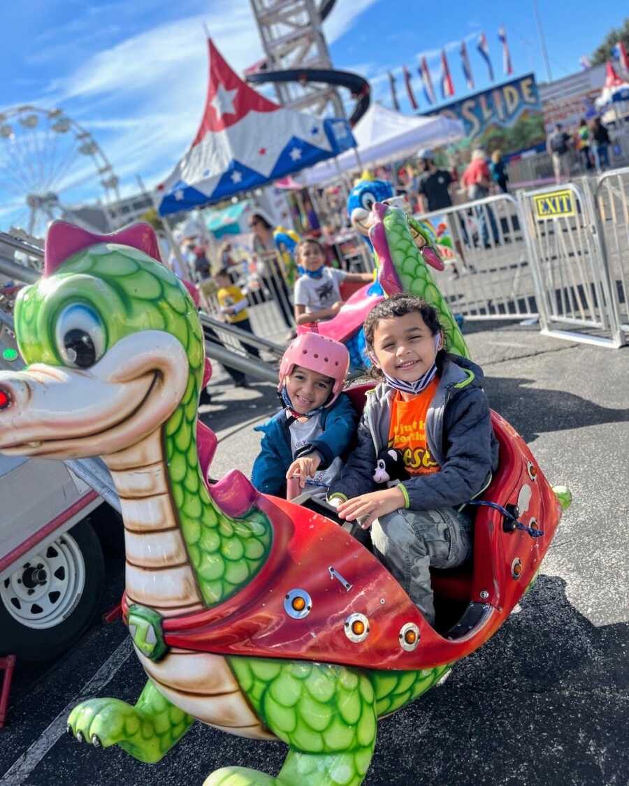 toddler boy at amusement park having fun