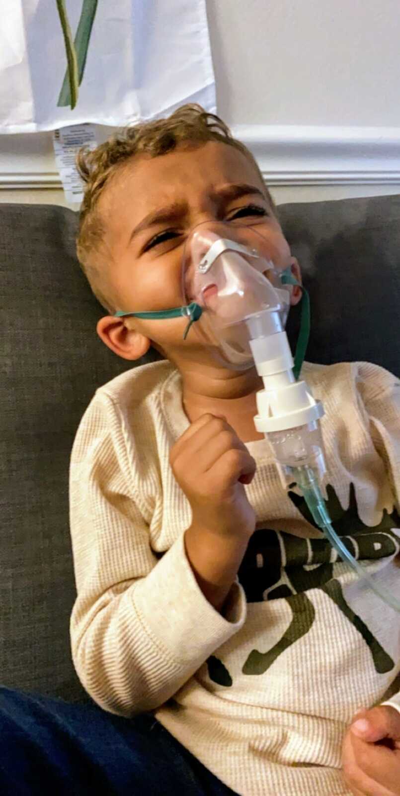 toddler boy doing breathing treatment