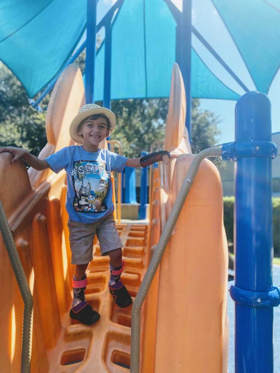 toddler boy happy at the jungle gym