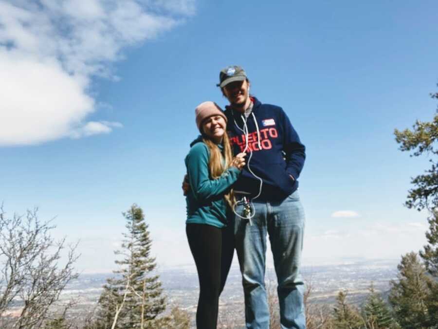 Woman and her partner outside on a hill