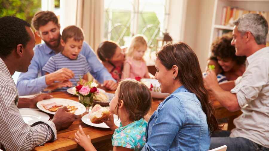 Family and friends gather together to enjoy a meal. 