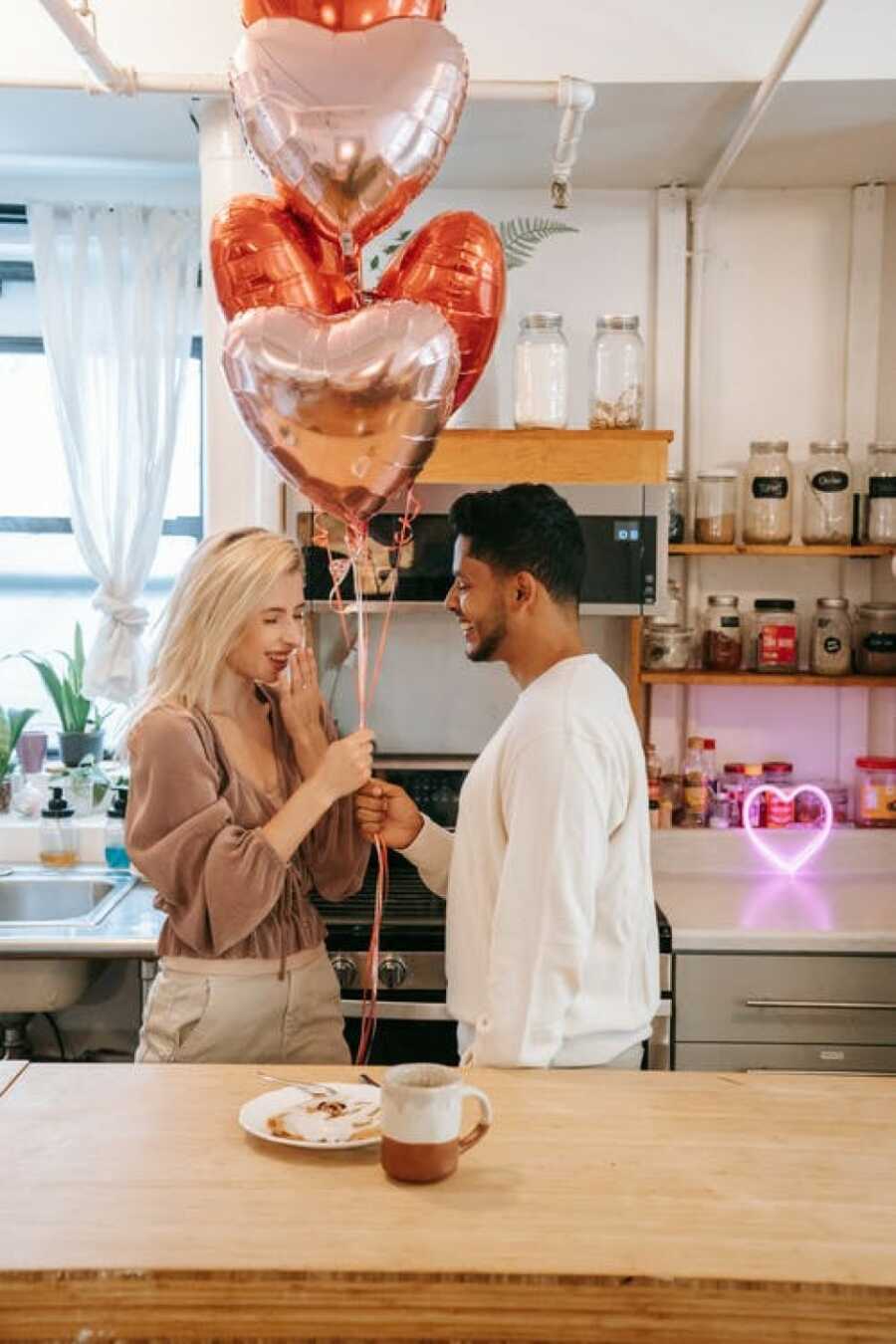 man giving his partner balloons to keep spark alive
