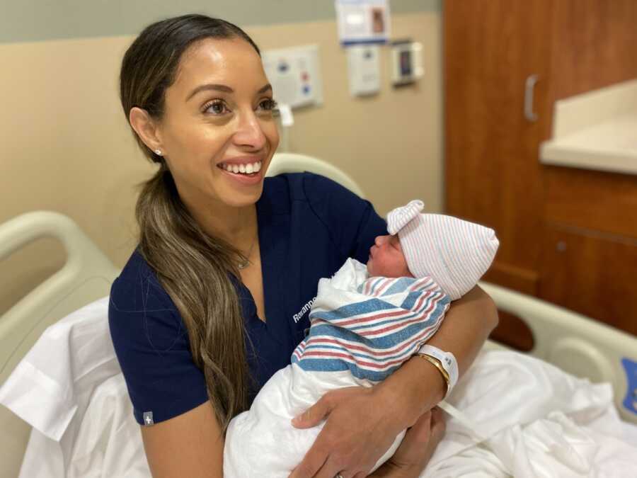 Roxanne holds their newborn baby girl and beams with joy. 