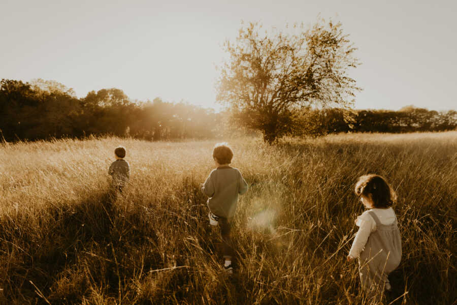 The Pero's oldest three children walk through the field. 