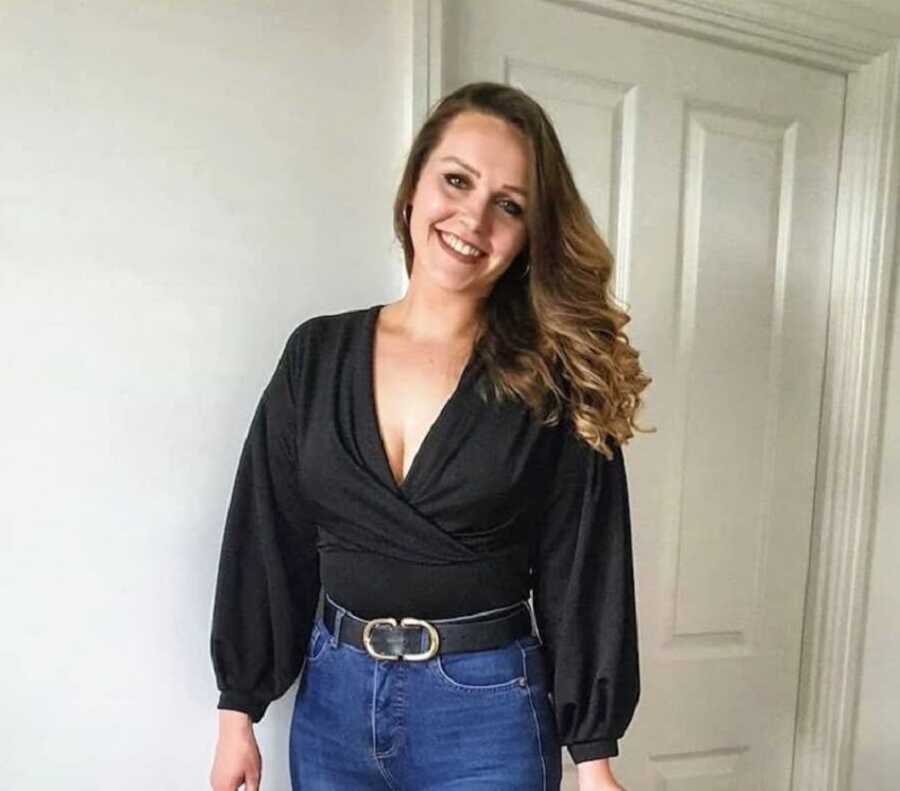 An autistic woman wearing a black shirt and jeans