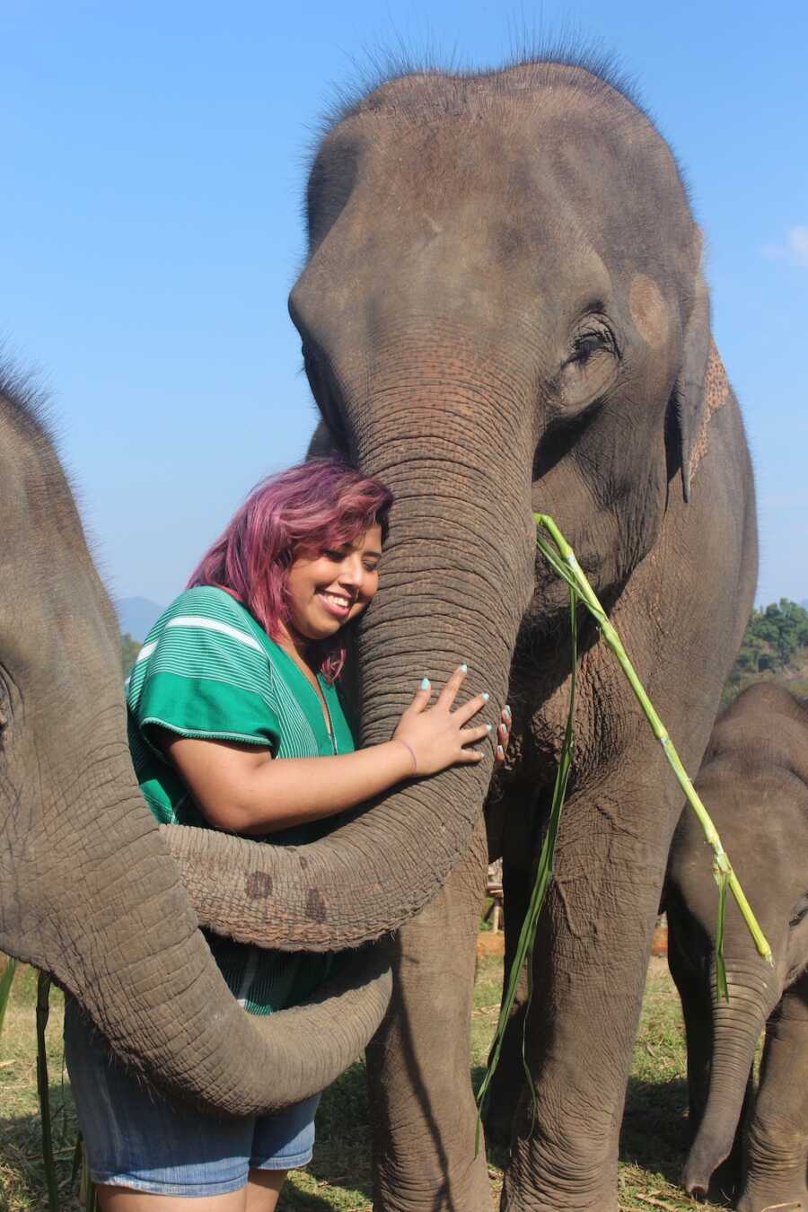 girl hugging an elephant
