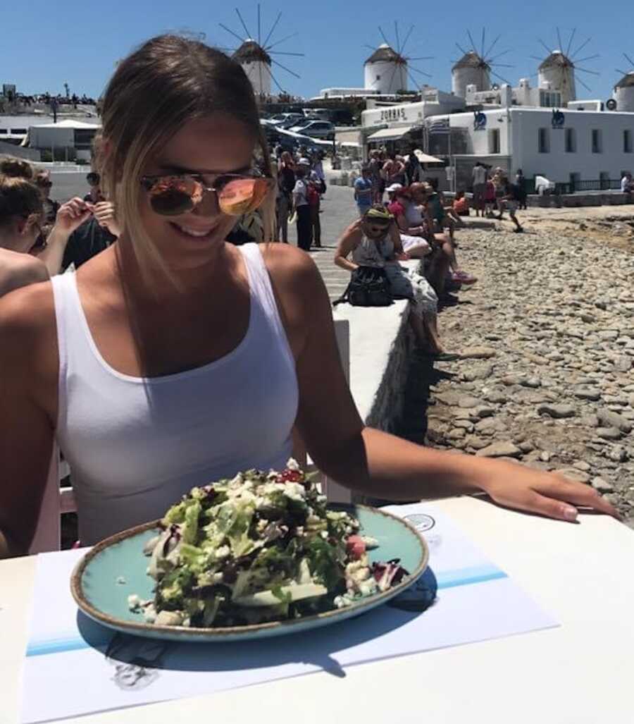 woman eating on a beach