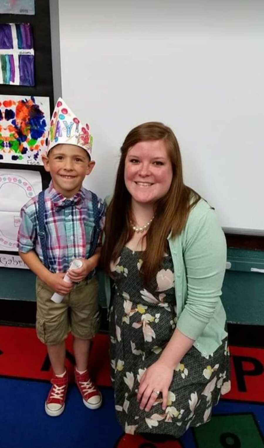 young boy and teacher smiling