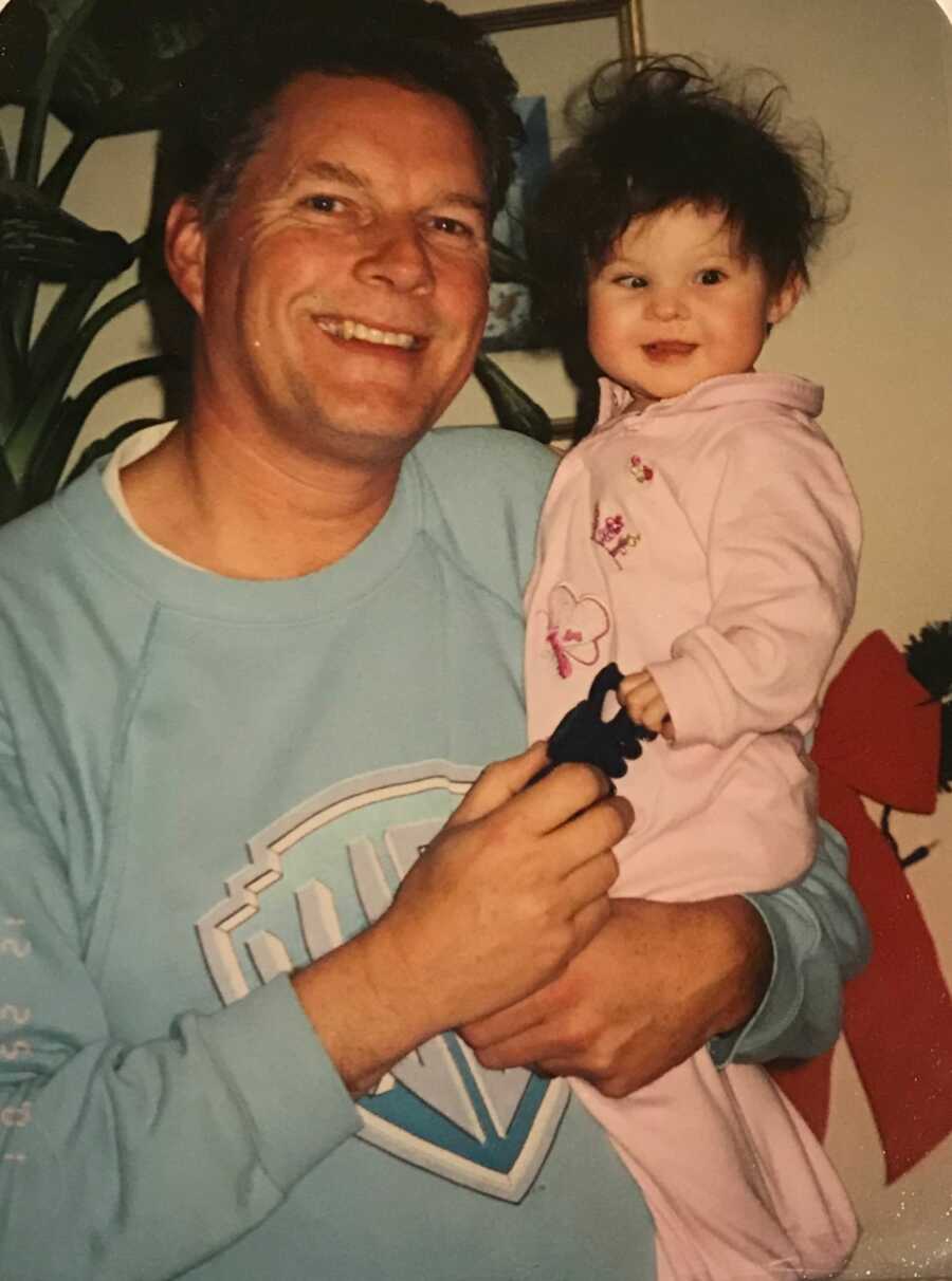 little girl being held by her dad