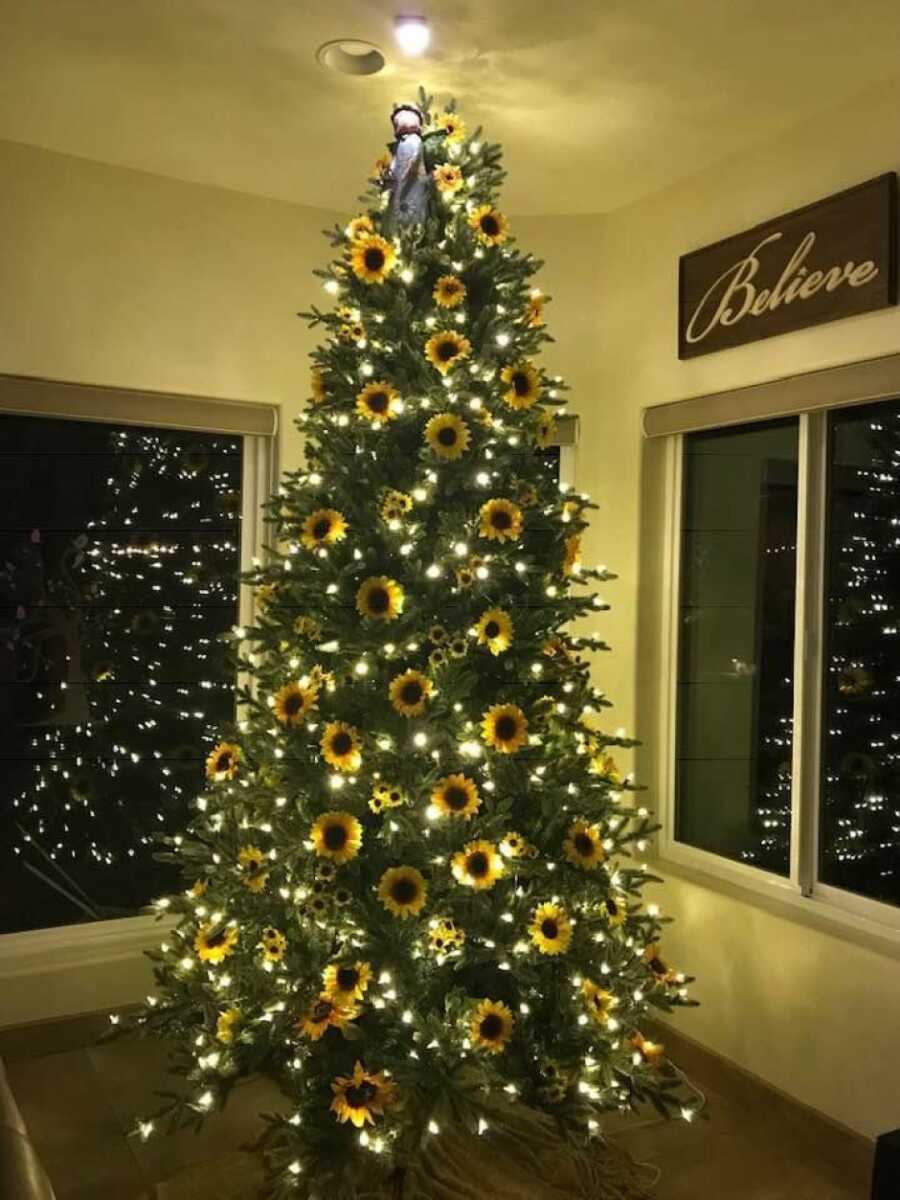 christmas tree with yellow lights and sunflowers