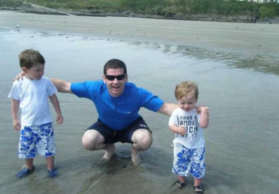 dad with his two boy at the beach