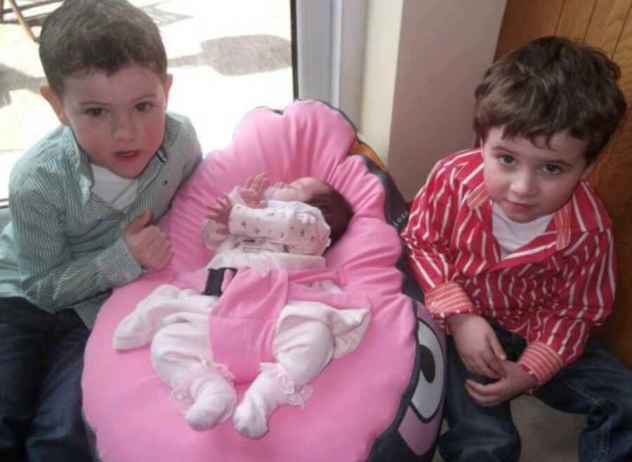 brothers with their new born sister