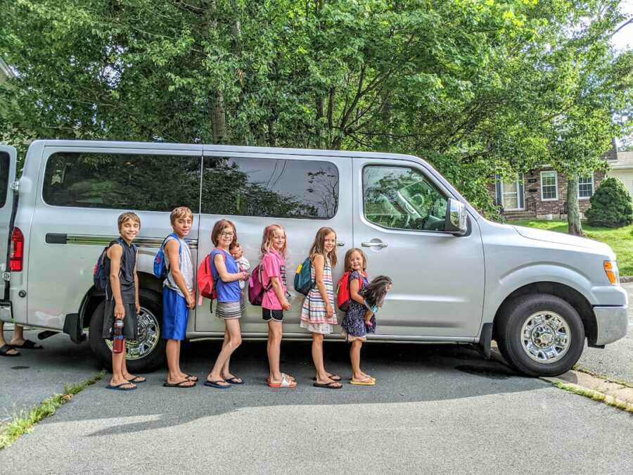 family in front of a van