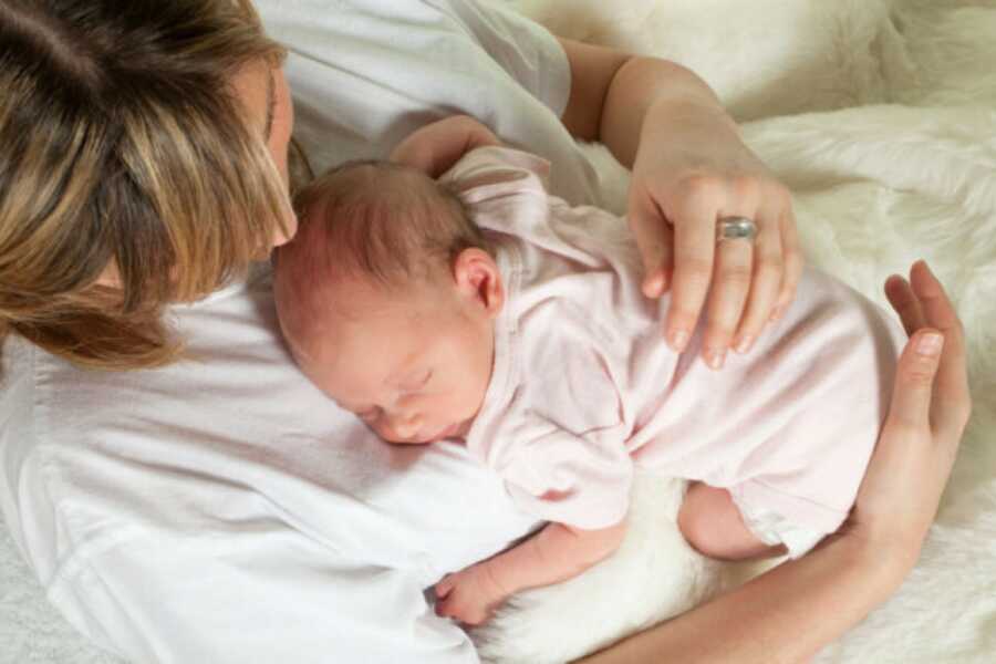 mom holding her baby on her chest after birth