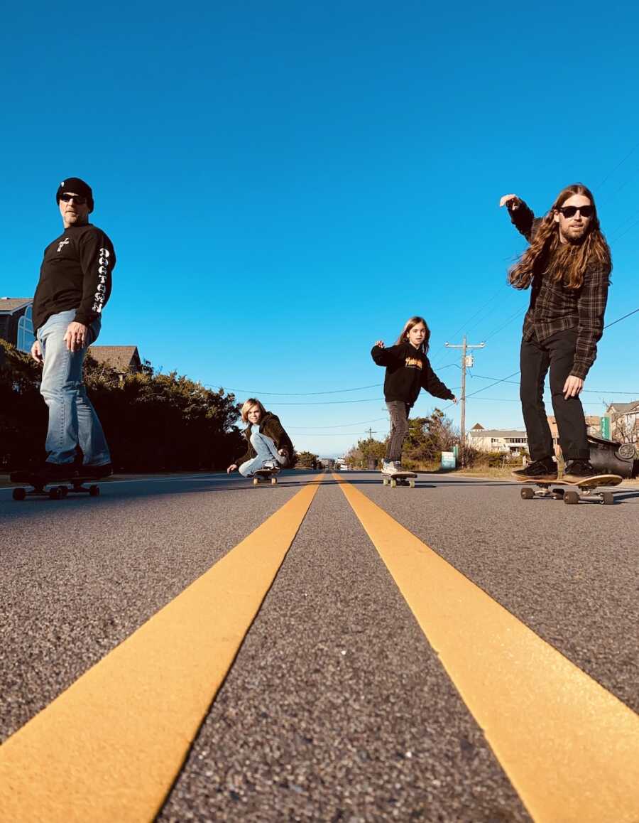 family skateboarding on a road