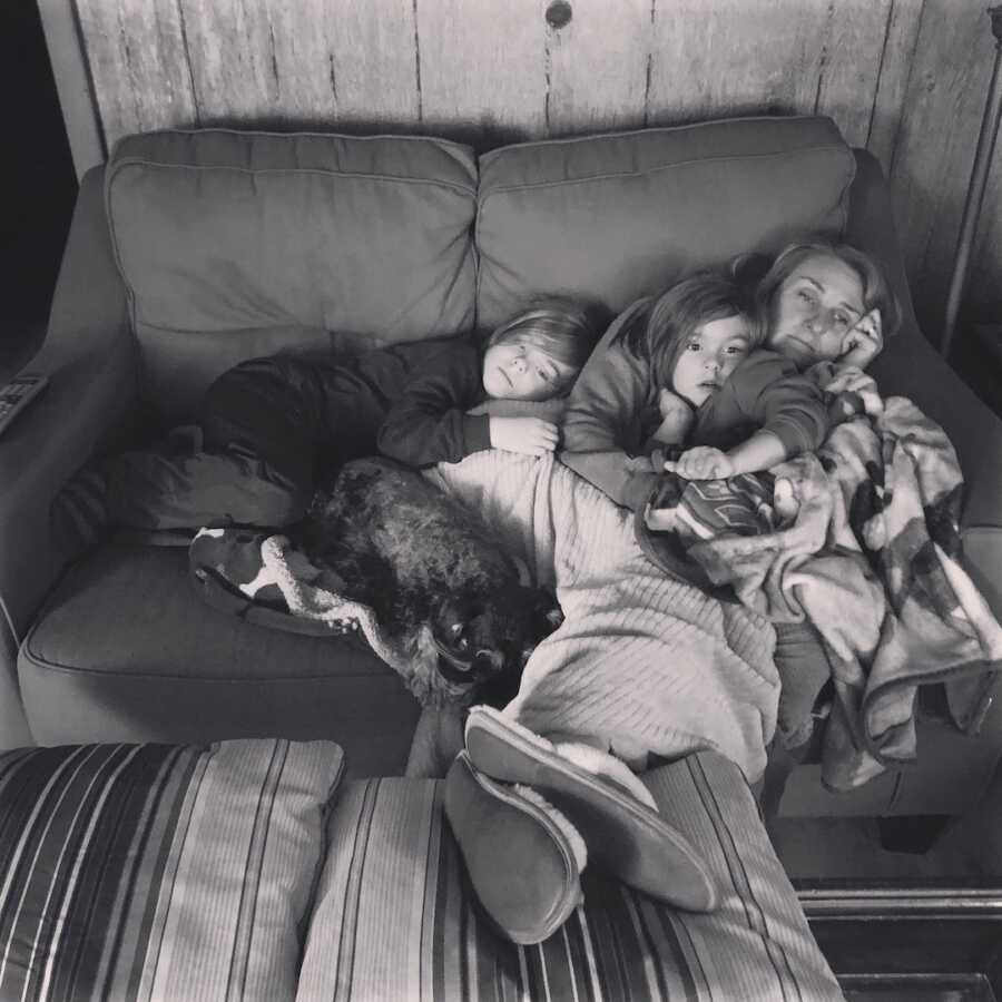 family snuggled on a couch together