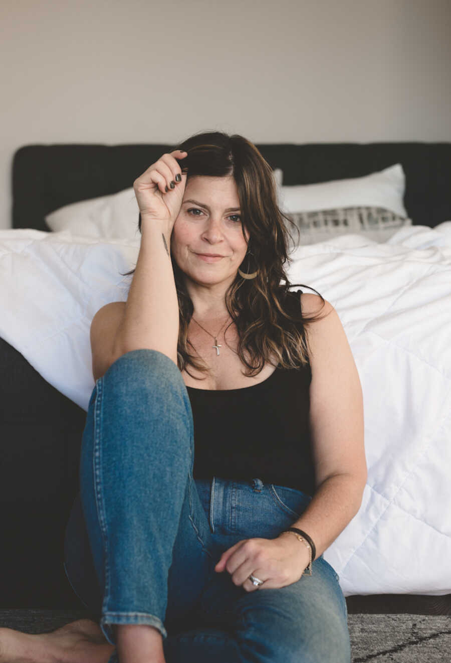 woman sitting on her bedroom floor