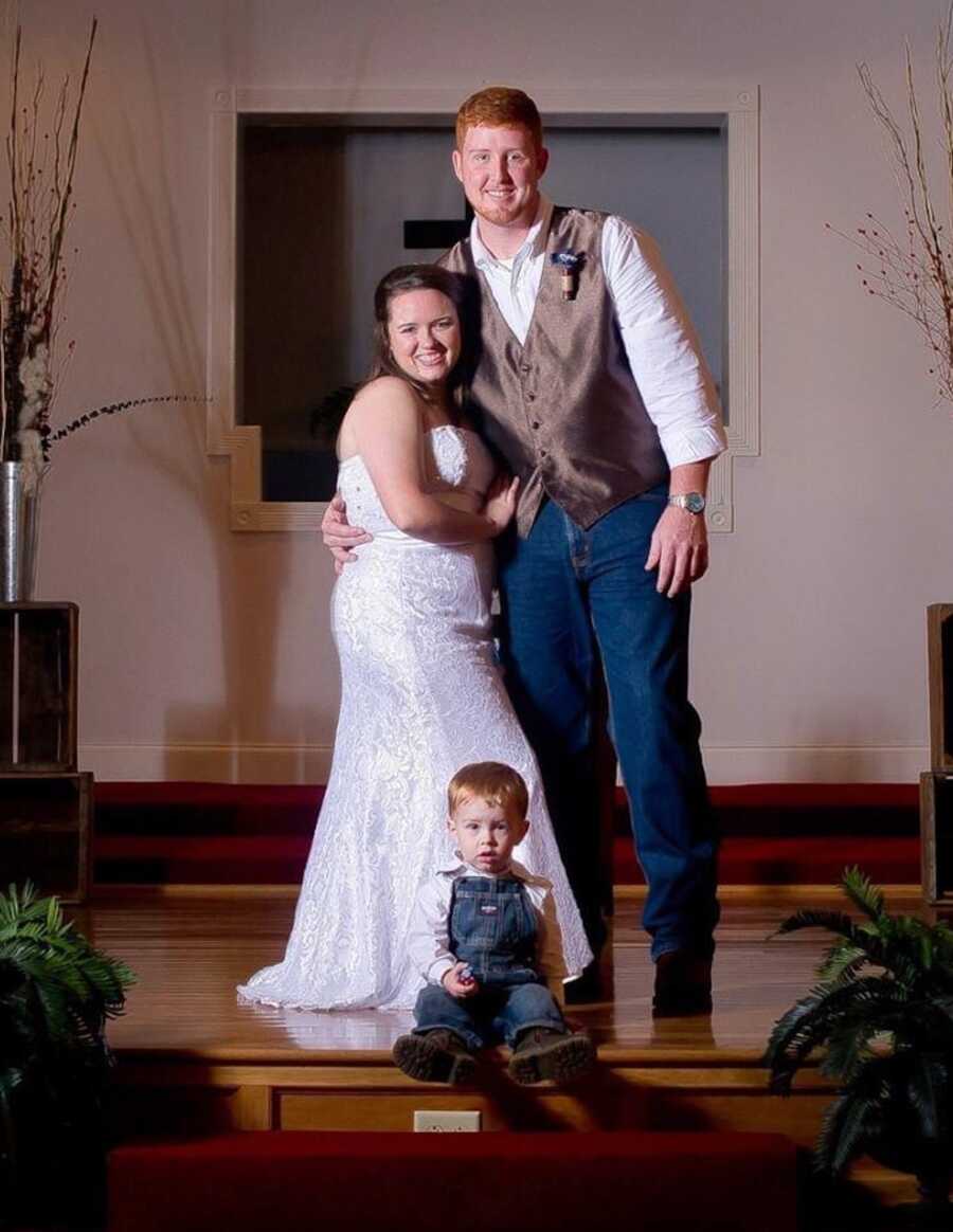 couple on their wedding day with their son