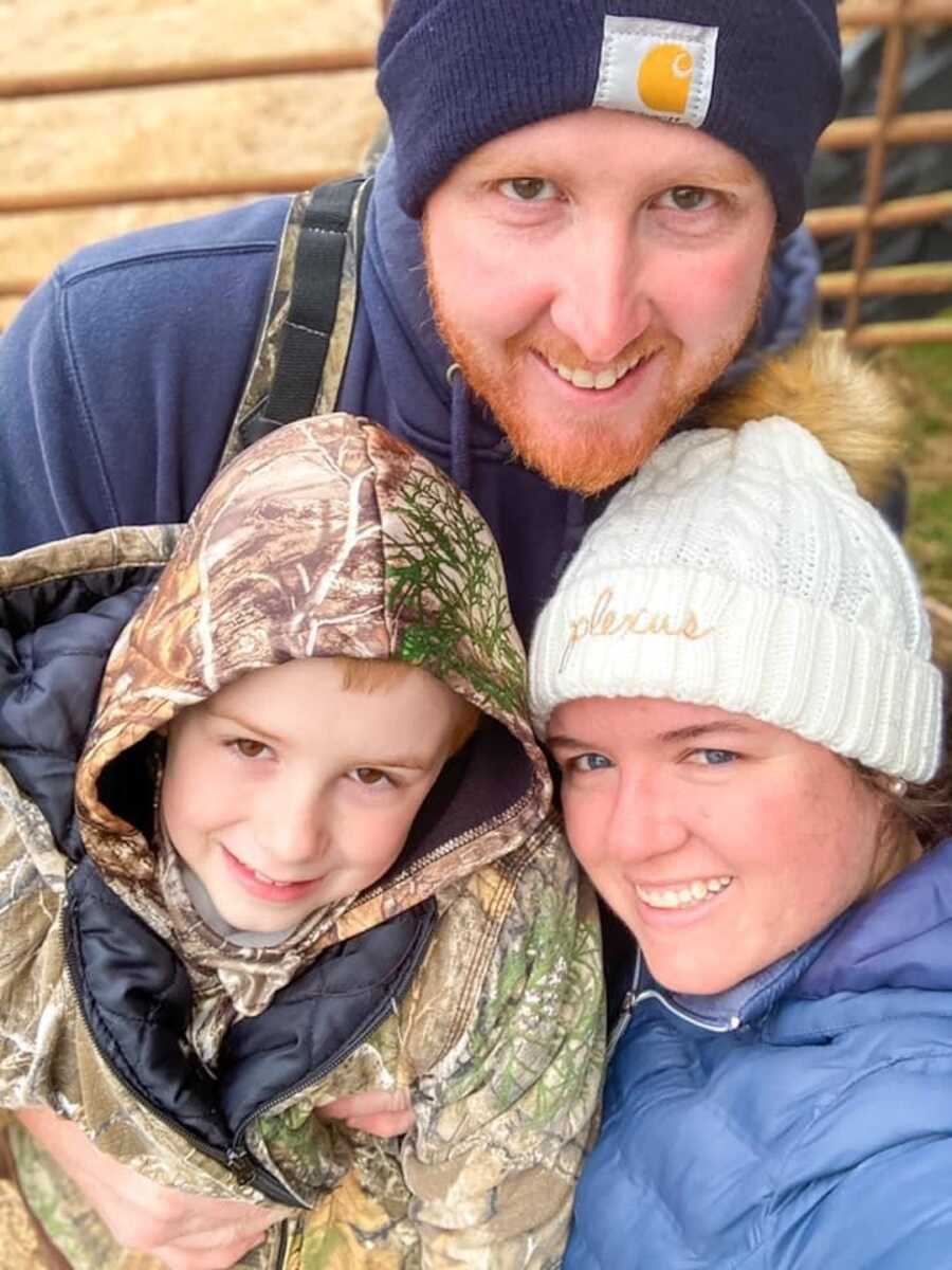 couple and their son smiling