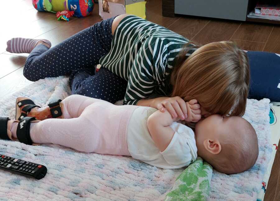 sister playing with her baby sister with SMA