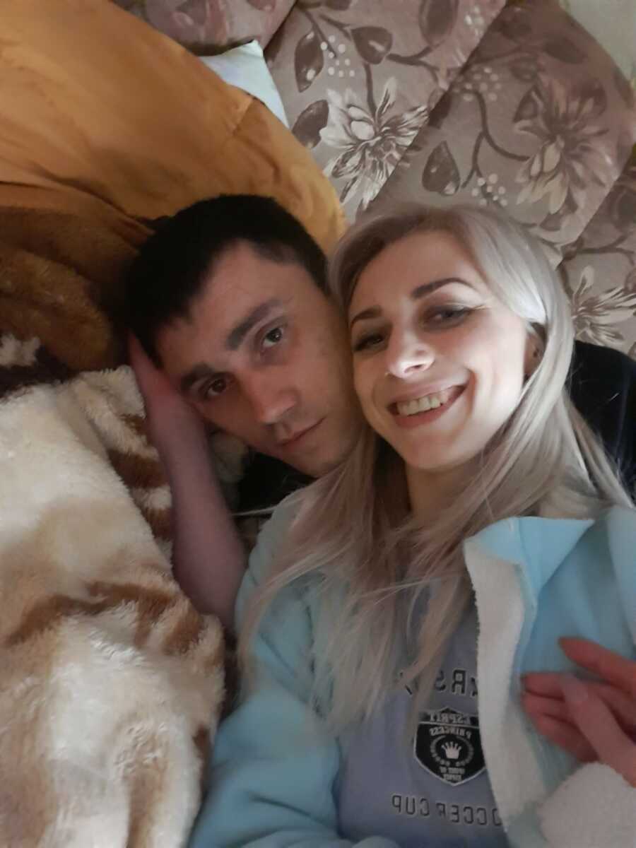 woman smiling and cuddling her with her then boyfriend