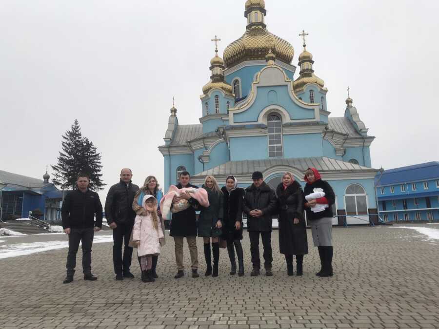 woman with her family after the baptism of her daughter with SMA