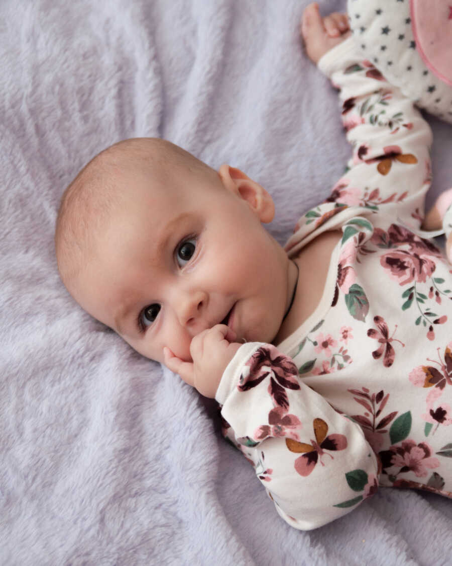 baby girl with SMA chewing her finger