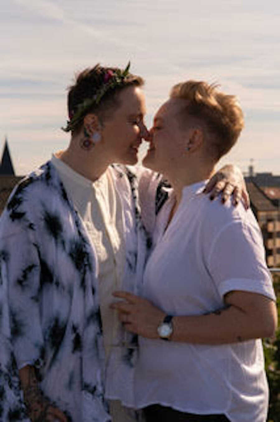 couple on their wedding day, outside, kissing