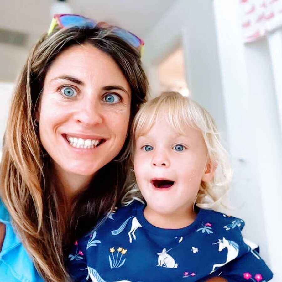 headshot of mother and daughter making silly faces 