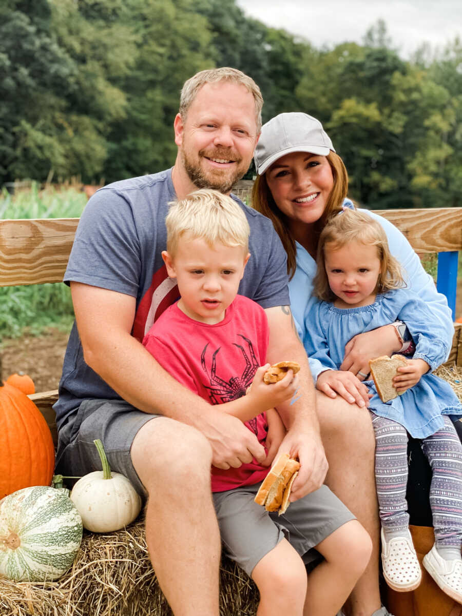 family posing in a garden