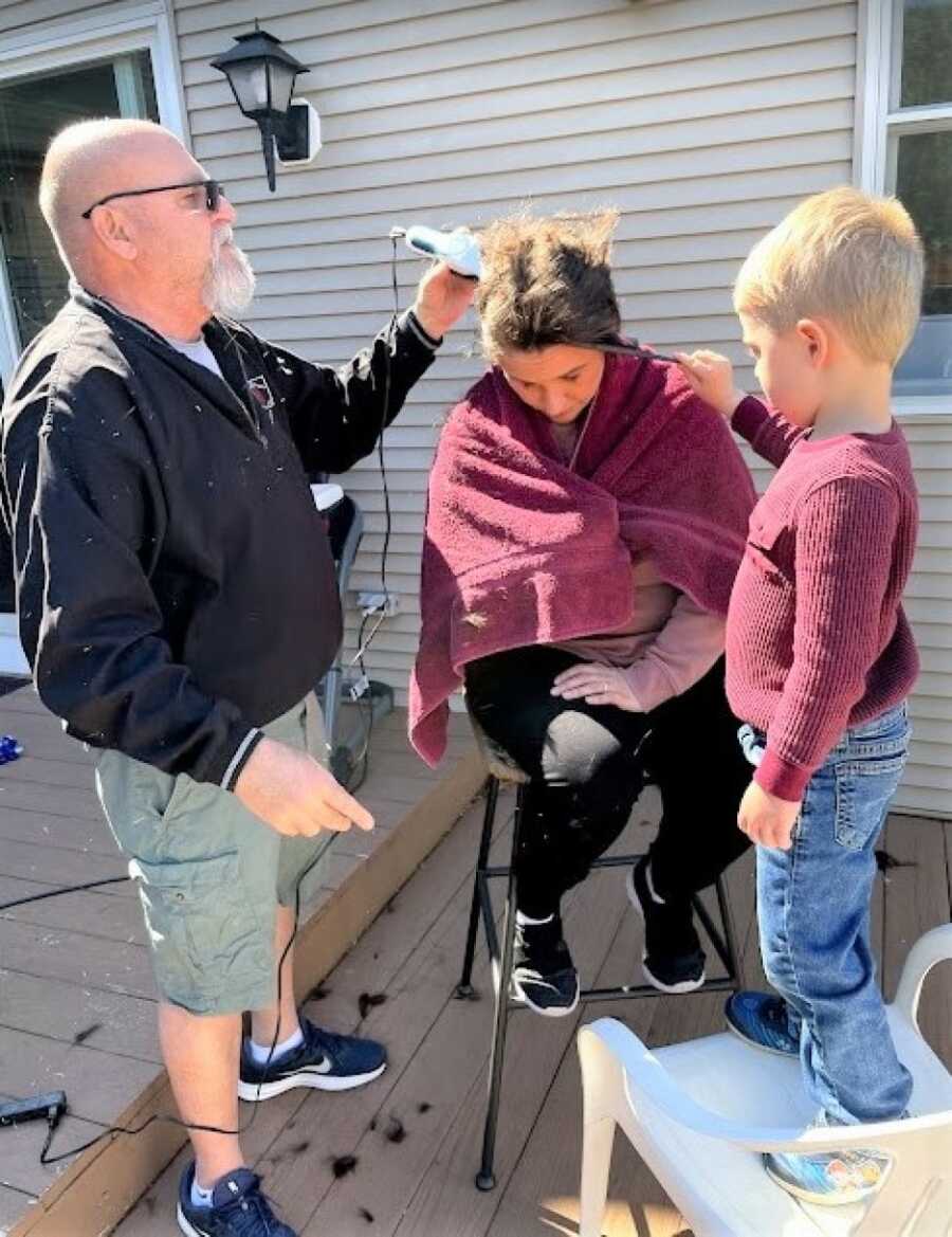 woman shaving her head