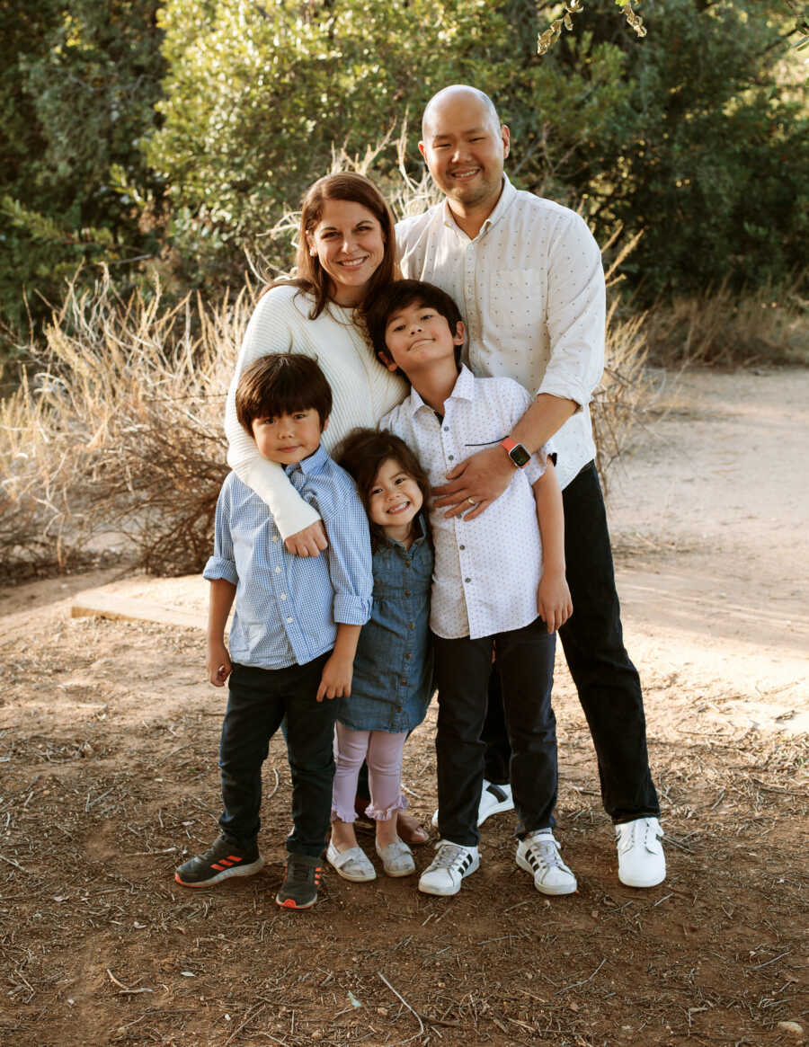 family posing outside