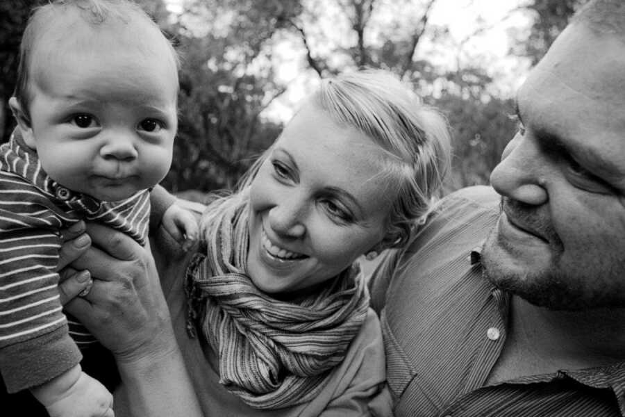 Jessica smiles with her baby boy and husband. 