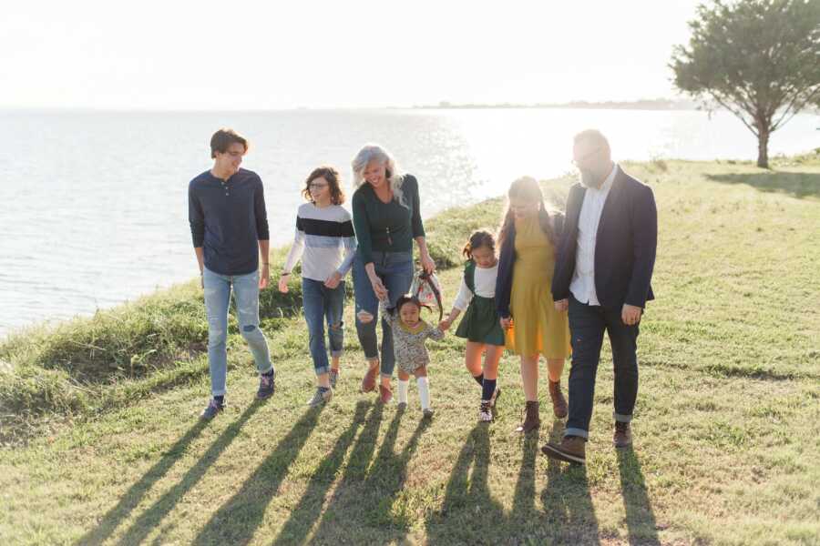 family photo on the grass by the water