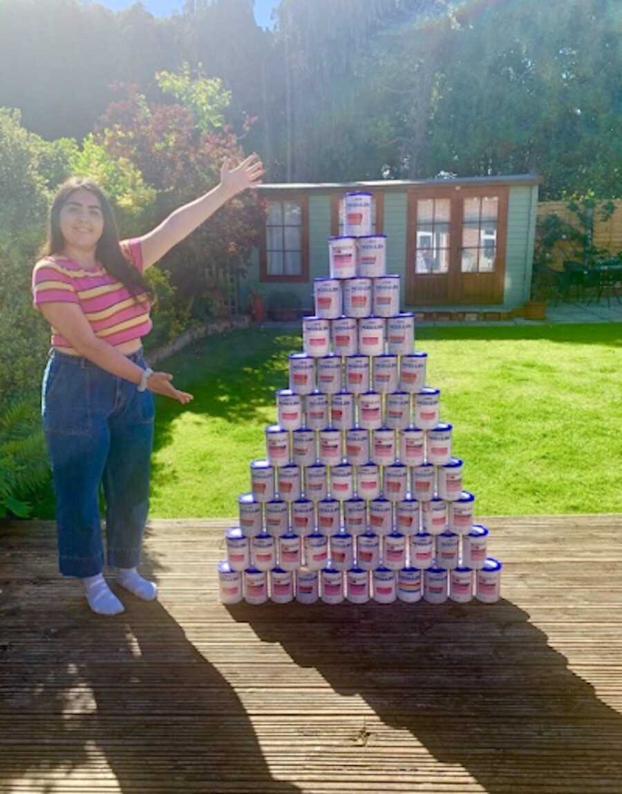 girl standing next to donations