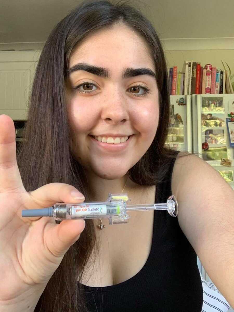 girl holding a needle