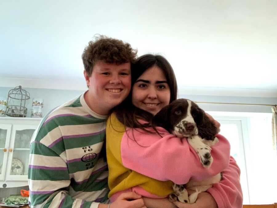 couple hugging with their dog