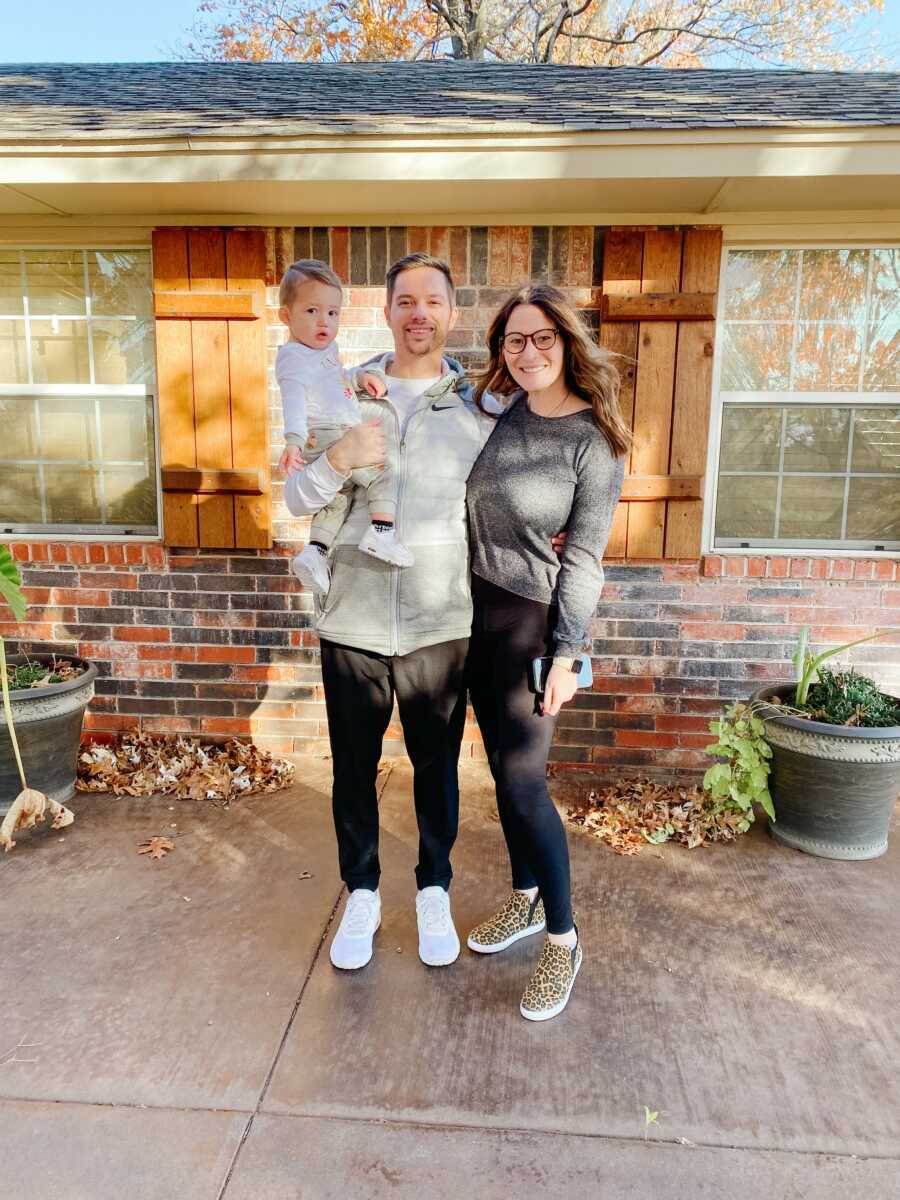 family taking a picture in front of their home together