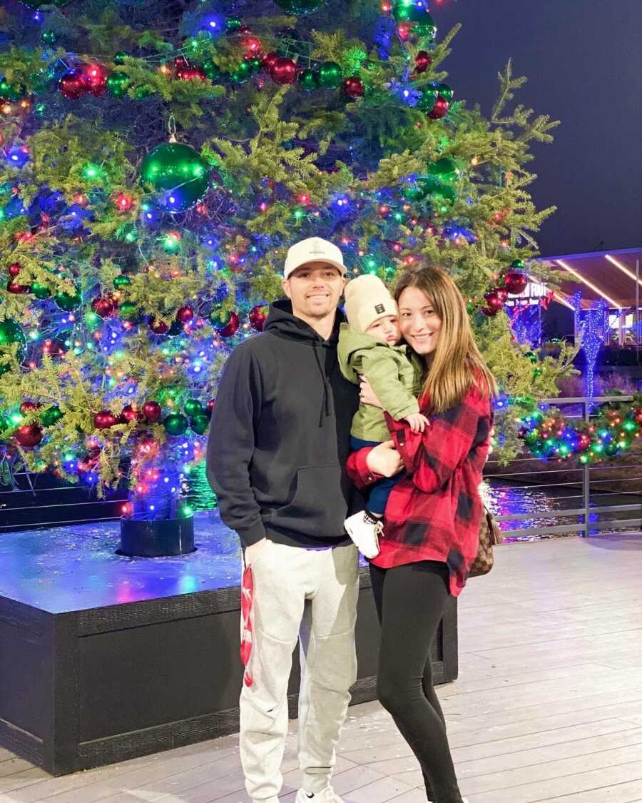 family in front of a christmas tree