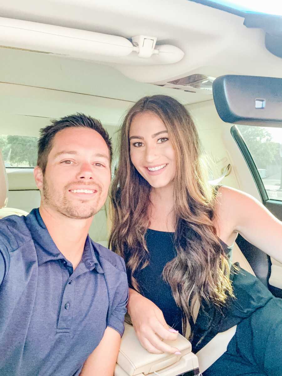 mom and dad posing in a car for a selfie