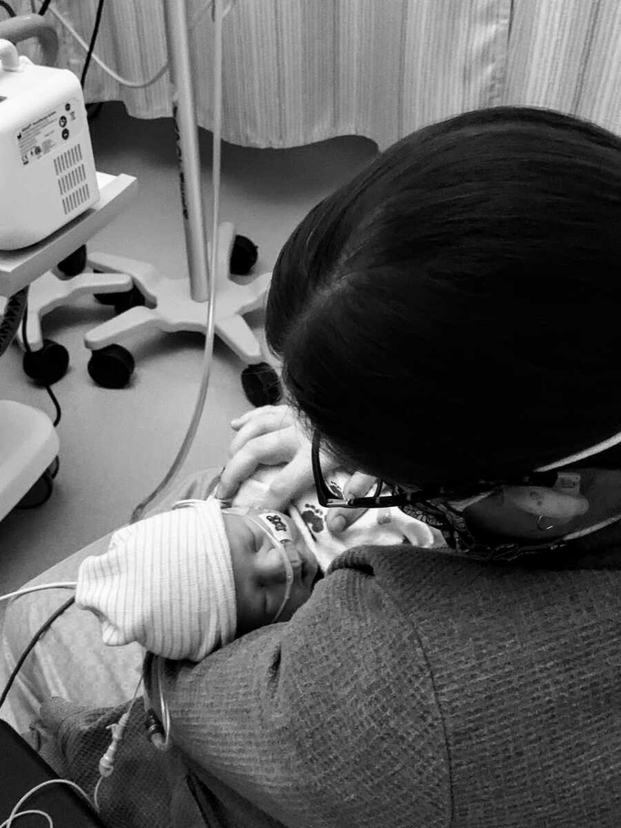 Mom holds newborn son in the hospital