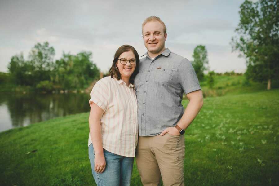 Couple smile big and hug during family photos