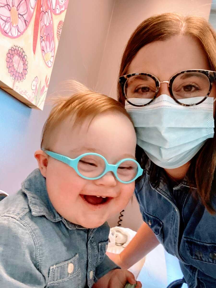 Special needs mom takes a selfie with her son with Down syndrome while at the doctor