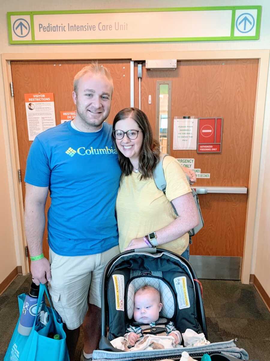 Couple take photo together on the day they brought their baby home from the NICU